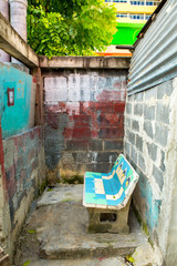 Old cement chair in a brick room