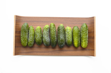 Cucumbers on the wooden tray. 
