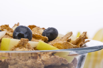 Muesli with apples and blueberries on white background