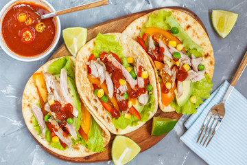 Fajitas with chicken, vegetables and spicy sauce salsa.