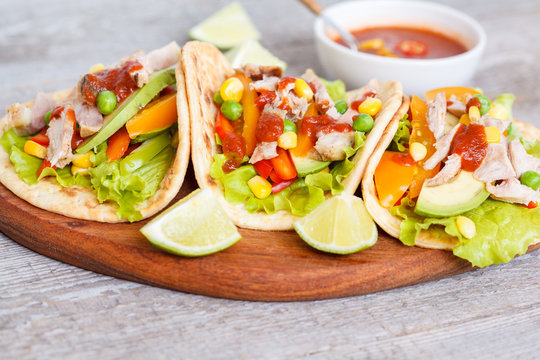 Fajitas with chicken, vegetables and spicy sauce salsa.