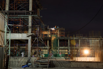 Construction site with Worker working at night