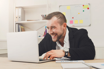 Young businessman gambling and gaming in the office