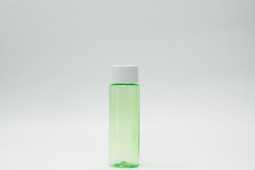 Green cosmetic bottle isolated on white background