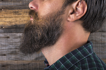  man beard and mustache over wooden background.Perfect beard