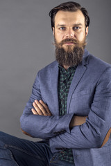  Elegant young fashion man with beard and mustache posing