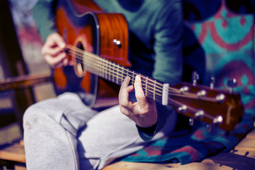 Obraz na płótnie Canvas Closeup of man playing an acoustic guitar