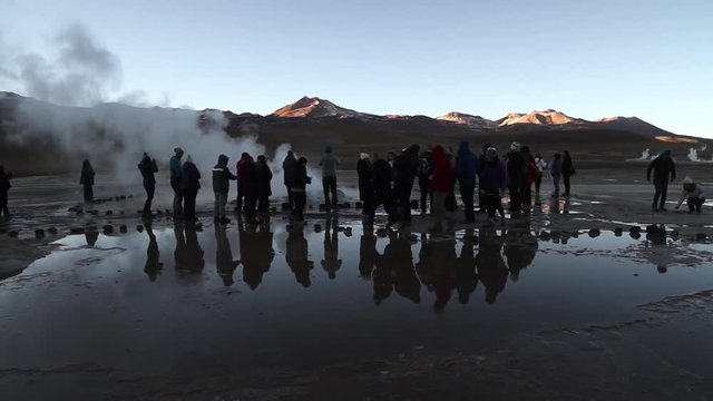 Tourists watching geysers