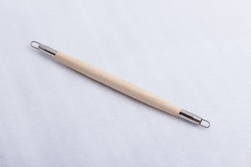 A sculpting tool on a white surface