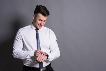Confident businessman checking hand watch time