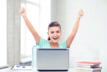 happy student girl with laptop at school