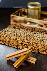 Dry pet food on black wooden table.