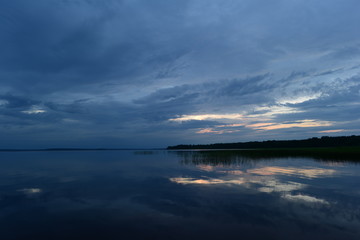 Fototapeta premium Sunset blue reflection on the lake water surface