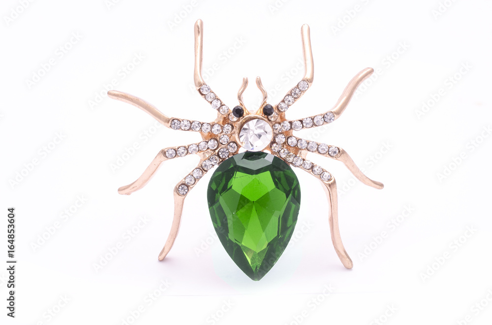 Wall mural Golden spider with a big green stone isolated on white