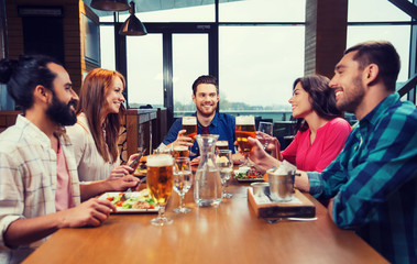 friends dining and drinking beer at restaurant