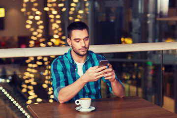 man with smartphone and coffee at restaurant
