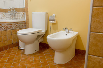 Toilet and bidet in modern bathroom