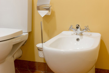 White ceramic bidet in modern bathroom.