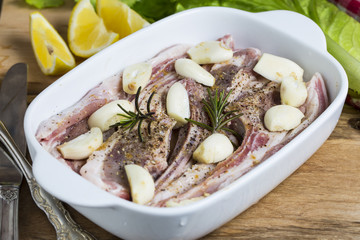 Raw lamb chops with spices and herbs close-up on wooden background