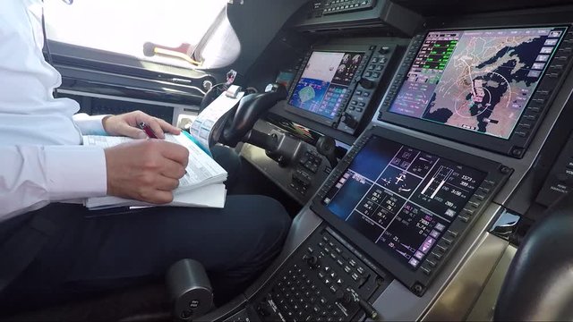 The automatic pilot controls the aircraft and man pilot does some paper work 