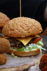 Big burger with pulled pork meat on wooden cut