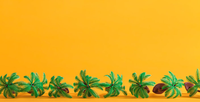 Tropical theme with little palm trees on a yellow background