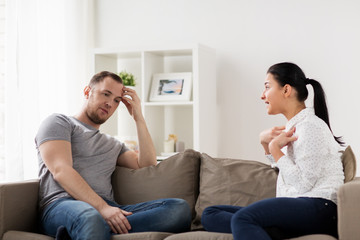 unhappy couple having argument at home