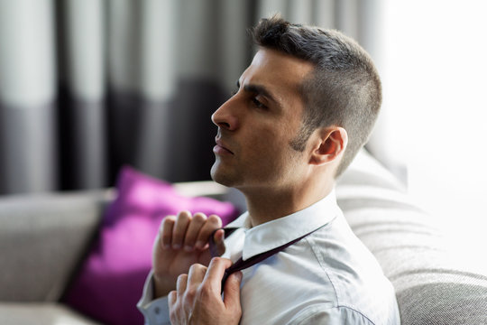 Businessman Taking Off His Tie At Hotel Room