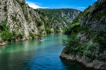 Motor boat in the lake of Canyon Matka in Macedonia - obrazy, fototapety, plakaty