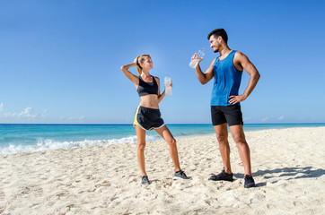 Couple taking a break after training at the beach