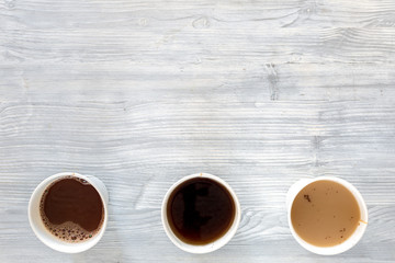 Coffee to go. Coffee cups on wooden table backound top view copyspace
