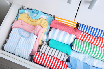 Chest of drawers with clothes in baby room