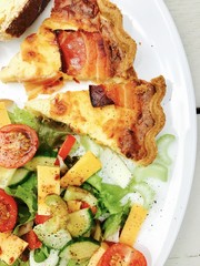 Quiche Lorraine with a mixed salad served on a white plate 
