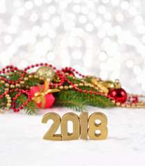 2018 year golden figures and spruce branch and Christmas decorations