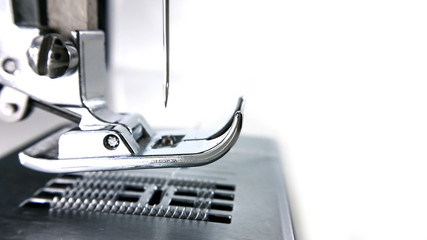Close-up detail of the sewing machine  and needle textile phase of over stitching .