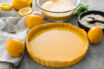 Uncooked lemon pie and ingredients on table