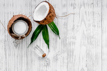 Organic cosmetics with coconut. Coconut oil on wooden background top view copyspace