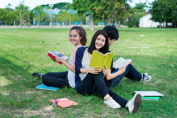 Young Students Group Smiling with Folders Book and Laptop computer Smiling on Grass in Education Campus University Top view