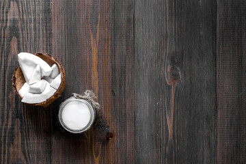 Skin care. Coconut oil on wooden table background top view copyspace