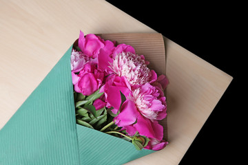 Beautiful bouquet with fragrant peonies on light wooden table