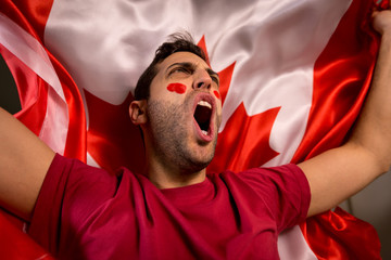 Fototapeta premium Canadian Guy Waving Canada Flag