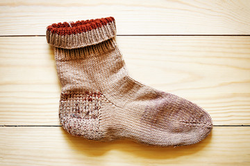 Wool sock on wooden background