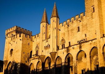 Palais des Papes Avignon at sunset, glowing orange