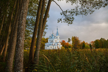 Sunset landscape of beautiful Orthodox church near lake with forest. Stameriena, Latvia.