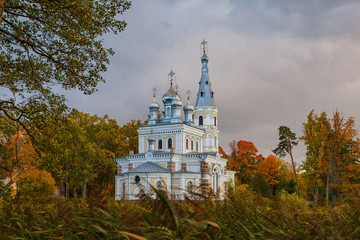 Fototapeta na wymiar Sunset landscape of beautiful Orthodox church near lake with forest. Stameriena, Latvia.
