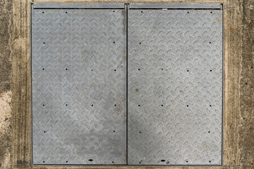 Background of Old metal diamond plate on concrete floor