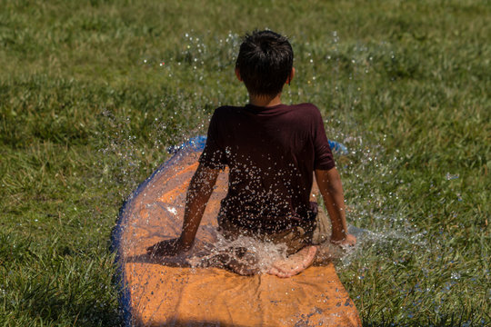 Young boy sliding in water