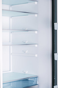 Empty open fridge with shelves