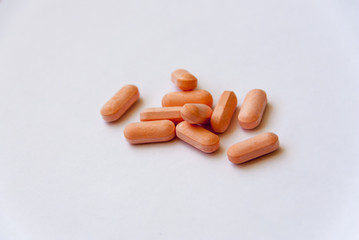 Orange pills on white background