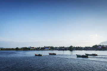 view of traditional fishing boats on kampot river in cambodia
